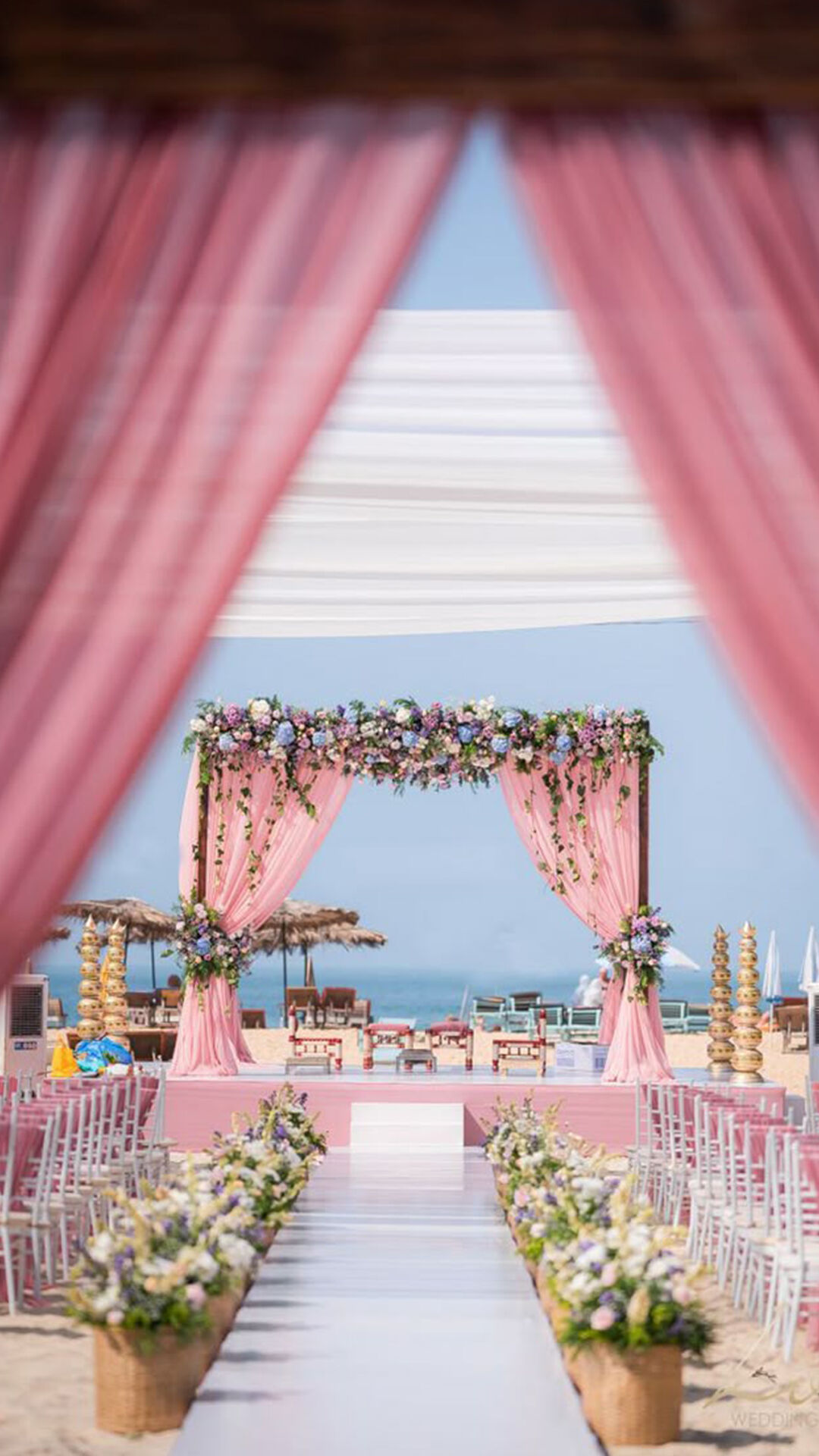 A pink theme wedding decoration, decorated with flowers on beach